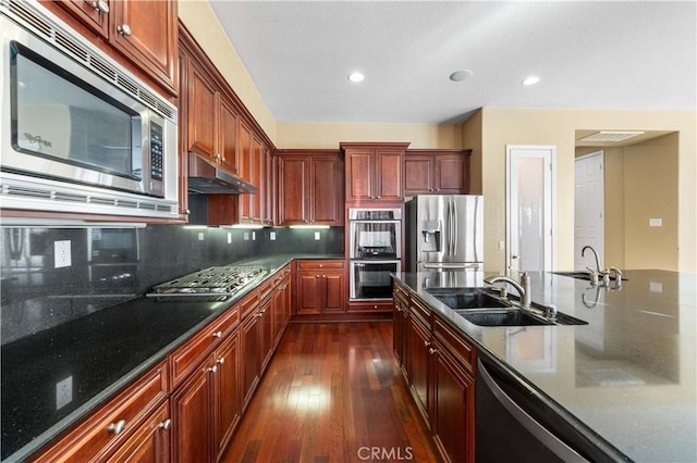 37351 Paintbrush Dr, Palmdale, CA 93551 - kitchen featuring stainless steel appliances, under cabinet range hood, dark wood-style floors, decorative backsplash, and recessed lighting