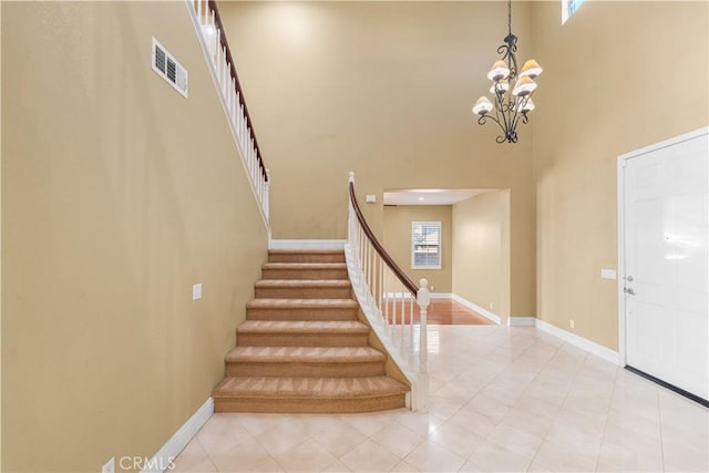 37351 Paintbrush Dr, Palmdale, CA 93551 - foyer with a towering ceiling, light tile patterned floors, stairs, and a chandelier
