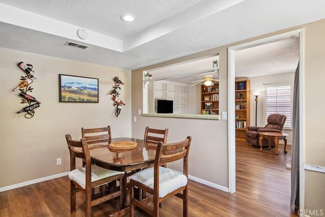 42724 Santa Suzanne Pl, Temecula, CA 92592 - dining room with wood finished floors, a ceiling fan, and a textured ceiling