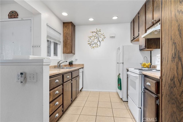 3639 Country Oaks Loop Unit E, Ontario, CA 91761 - kitchen with white appliances, under cabinet range hood, light countertops, light tile patterned flooring, and dark brown cabinets