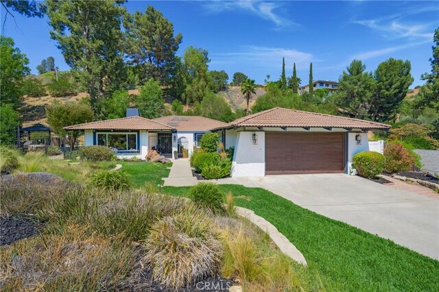 170 Buckthorn Dr, Brea, CA 92823 - mediterranean / spanish home with stucco siding, concrete driveway, a garage, and a chimney