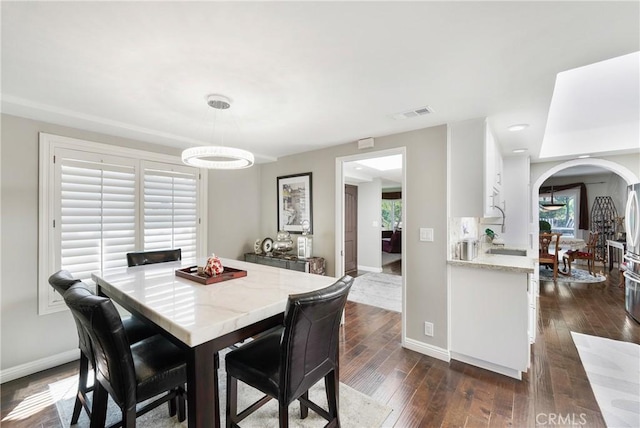 170 Buckthorn Dr, Brea, CA 92823 - dining area with arched walkways and dark wood-type flooring