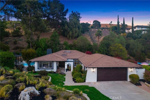 170 Buckthorn Dr, Brea, CA 92823 - view of front facade with a garage, a chimney, driveway, stucco siding, and a tiled roof