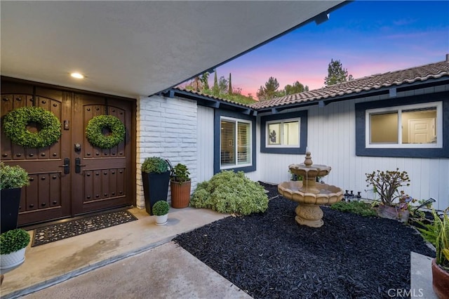 170 Buckthorn Dr, Brea, CA 92823 - exterior entry at dusk with a tile roof