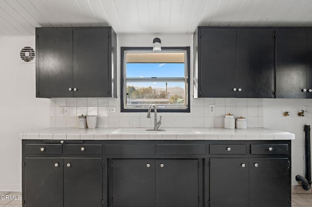17002 E Nubia St, Covina, CA 91722 - kitchen featuring tasteful backsplash, tile patterned flooring, wood ceiling, and light countertops
