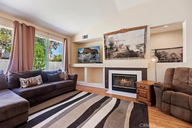 27185 Buffalo Trl, Corona, CA 92883 - living area featuring light wood finished floors, lofted ceiling, and a fireplace