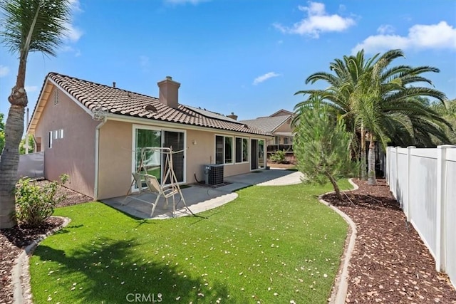 27185 Buffalo Trl, Corona, CA 92883 - rear view of house with stucco siding, a chimney, a fenced backyard, and a patio