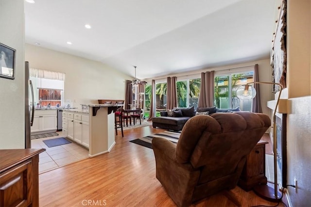 27185 Buffalo Trl, Corona, CA 92883 - living area featuring healthy amount of natural light, vaulted ceiling, light wood-style flooring, ceiling fan, and recessed lighting