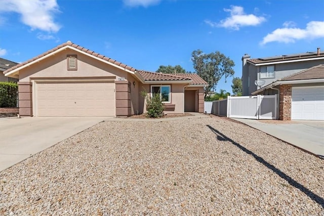 27185 Buffalo Trl, Corona, CA 92883 - view of front facade with driveway, stucco siding, an attached garage, and a tile roof