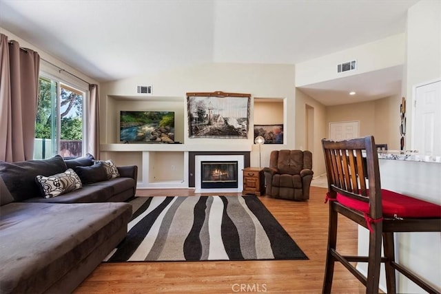 27185 Buffalo Trl, Corona, CA 92883 - living area featuring light wood-type flooring and a glass covered fireplace