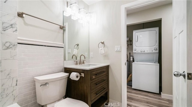 72160 Winters Rd Unit 29, Palms, CA 92277 - full bathroom with stacked washer / dryer, vanity, and wood finished floors