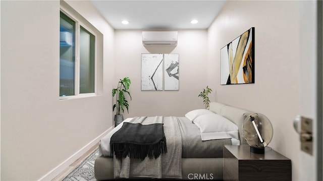 72160 Winters Rd Unit 29, Palms, CA 92277 - bedroom with a wall mounted AC, recessed lighting, and wood finished floors