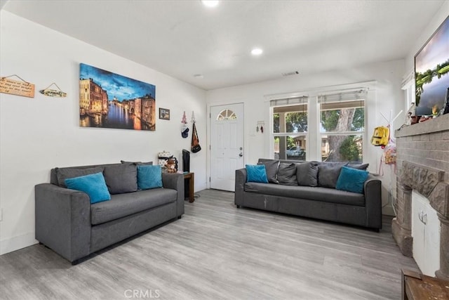 2838 N G St, San Bernardino, CA 92405 - living area featuring light wood-style floors, a fireplace, and recessed lighting