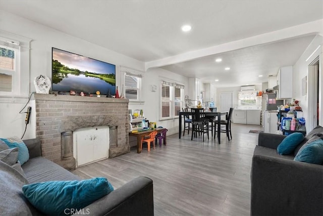 2838 N G St, San Bernardino, CA 92405 - living room with recessed lighting, light wood-style floors, a brick fireplace, and washer / clothes dryer