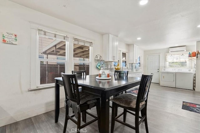2838 N G St, San Bernardino, CA 92405 - dining area featuring washing machine and clothes dryer, light wood finished floors, an AC wall unit, healthy amount of natural light, and recessed lighting