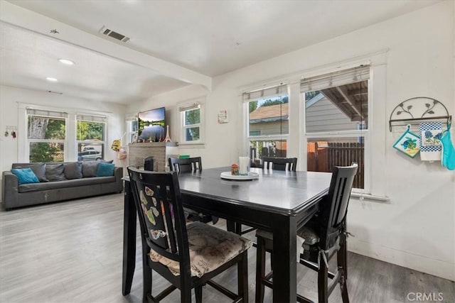 2838 N G St, San Bernardino, CA 92405 - dining space featuring wood finished floors, a fireplace, and recessed lighting