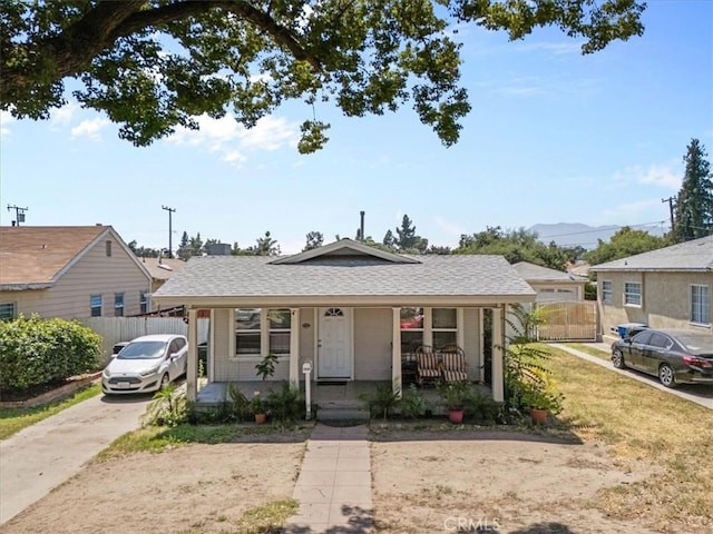 2838 N G St, San Bernardino, CA 92405 - bungalow-style house featuring covered porch, a shingled roof, and concrete driveway