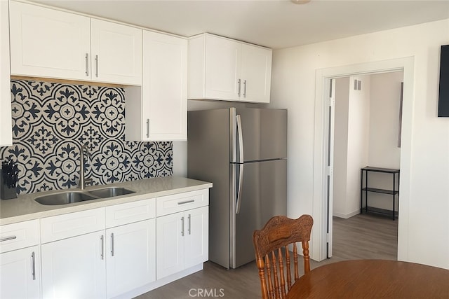 2838 N G St, San Bernardino, CA 92405 - kitchen with freestanding refrigerator, dark wood finished floors, light countertops, and backsplash