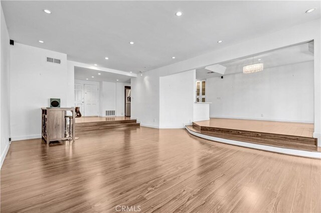 5333 Zelzah Ave Unit 203, Encino, CA 91316 - unfurnished living room featuring wood finished floors and recessed lighting