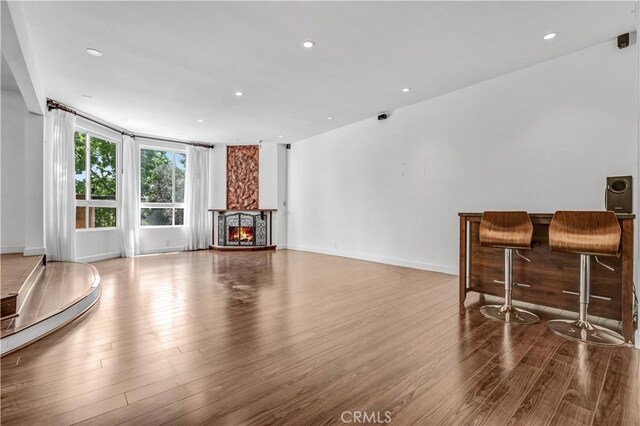 5333 Zelzah Ave Unit 203, Encino, CA 91316 - living area with wood finished floors, recessed lighting, and a lit fireplace