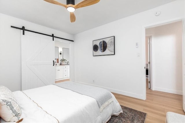 5447 Columbus Ave, Sherman Oaks, CA 91411 - bedroom with a barn door, light wood-type flooring, and ceiling fan