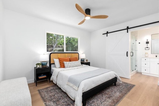 5447 Columbus Ave, Sherman Oaks, CA 91411 - bedroom with a barn door, light wood finished floors, and a ceiling fan
