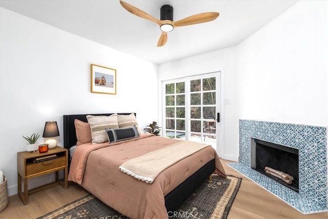 5447 Columbus Ave, Sherman Oaks, CA 91411 - bedroom featuring wood finished floors, a fireplace, and a ceiling fan
