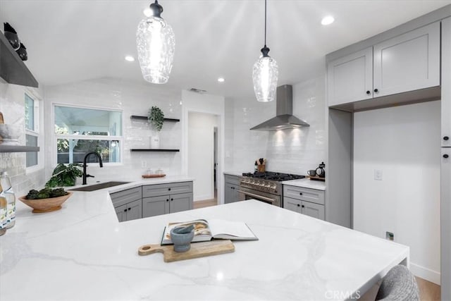 5447 Columbus Ave, Sherman Oaks, CA 91411 - kitchen with wall chimney exhaust hood, high end stove, open shelves, gray cabinets, and decorative backsplash