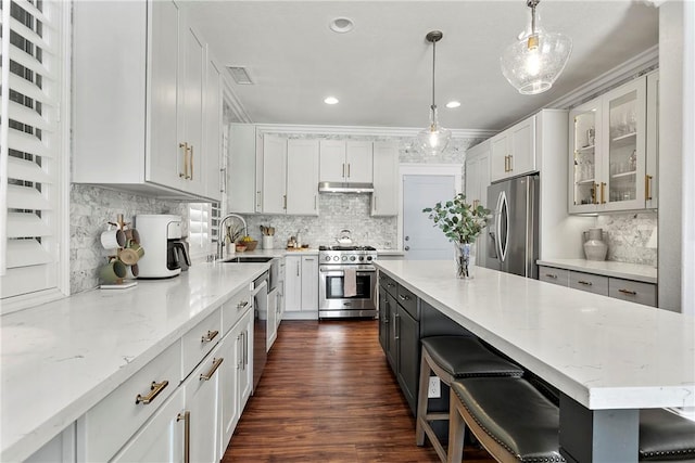 23763 Aspen, Murrieta, CA 92562 - kitchen with stainless steel appliances, ornamental molding, backsplash, white cabinetry, and light stone countertops