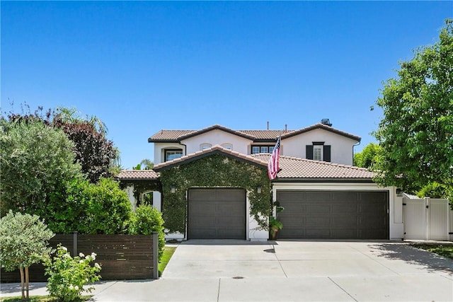23763 Aspen, Murrieta, CA 92562 - mediterranean / spanish-style home featuring an attached garage, driveway, a tiled roof, and stucco siding