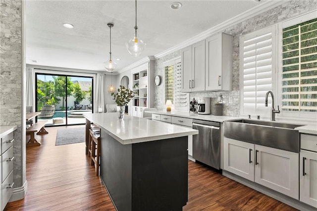 23763 Aspen, Murrieta, CA 92562 - kitchen with stainless steel dishwasher, ornamental molding, light countertops, dark wood-type flooring, and a center island