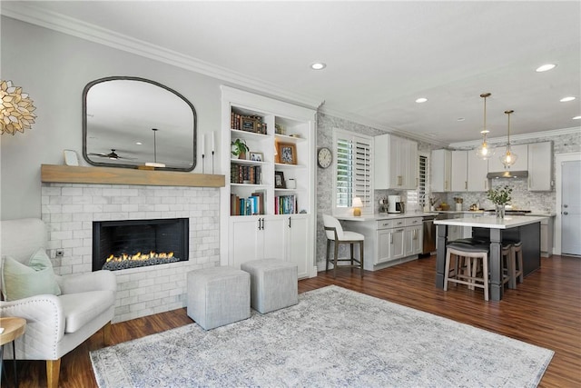 23763 Aspen, Murrieta, CA 92562 - living area with ornamental molding, a ceiling fan, recessed lighting, dark wood finished floors, and a fireplace
