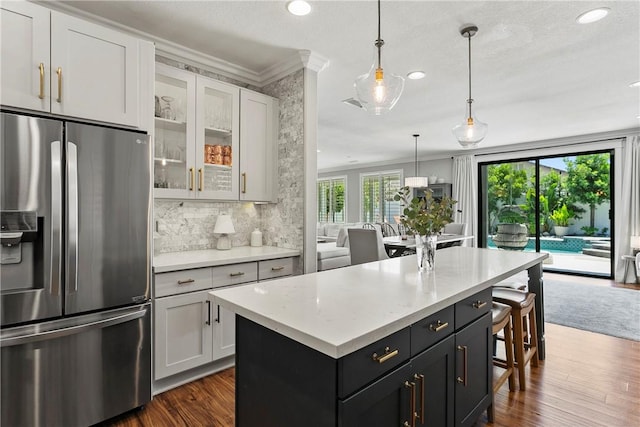 23763 Aspen, Murrieta, CA 92562 - kitchen featuring stainless steel fridge with ice dispenser, ornamental molding, dark wood-style floors, a kitchen island, and recessed lighting