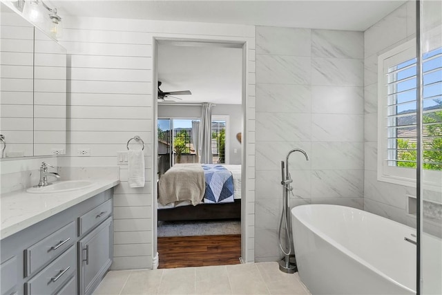 23763 Aspen, Murrieta, CA 92562 - bathroom with vanity, tile patterned floors, plenty of natural light, a soaking tub, and tile walls