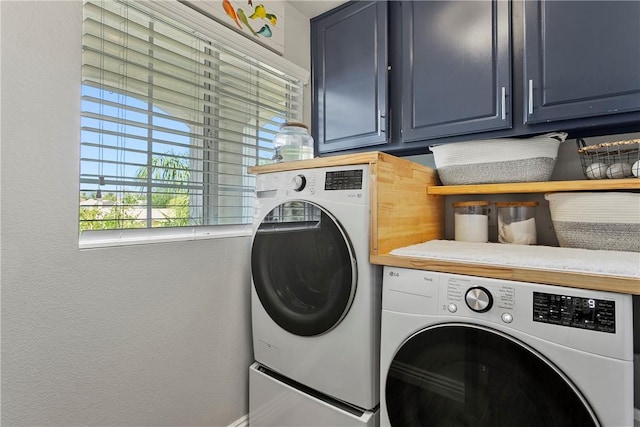 23763 Aspen, Murrieta, CA 92562 - laundry area featuring washing machine and clothes dryer, cabinet space, and a textured wall
