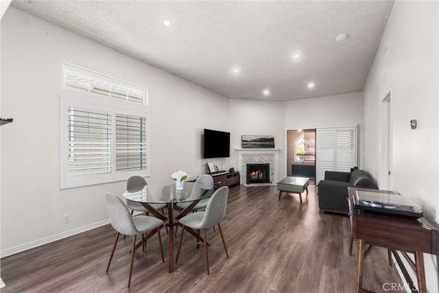 1867 W Falmouth Ave Unit 60, Anaheim, CA 92801 - dining area featuring recessed lighting, a textured ceiling, dark wood-type flooring, and a fireplace