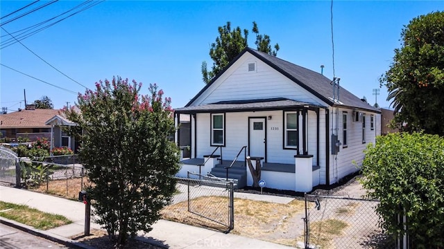 1235 Spruce St, San Bernardino, CA 92411 - view of front of home featuring a fenced front yard, a porch, and a gate