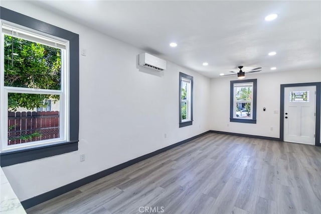 1235 Spruce St, San Bernardino, CA 92411 - spare room featuring recessed lighting, light wood-style floors, ceiling fan, and a wall unit AC
