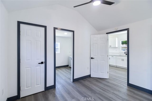 1235 Spruce St, San Bernardino, CA 92411 - unfurnished bedroom with vaulted ceiling, dark wood-style flooring, connected bathroom, and ceiling fan