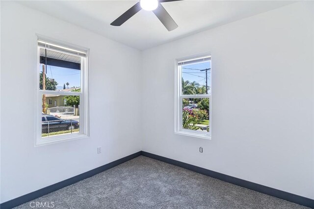 1235 Spruce St, San Bernardino, CA 92411 - empty room with a ceiling fan and carpet floors