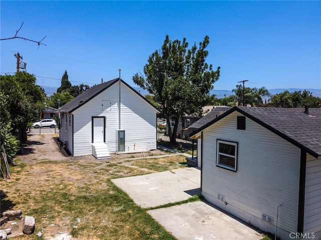 1235 Spruce St, San Bernardino, CA 92411 - back of house with a patio area, crawl space, a lawn, and a shingled roof