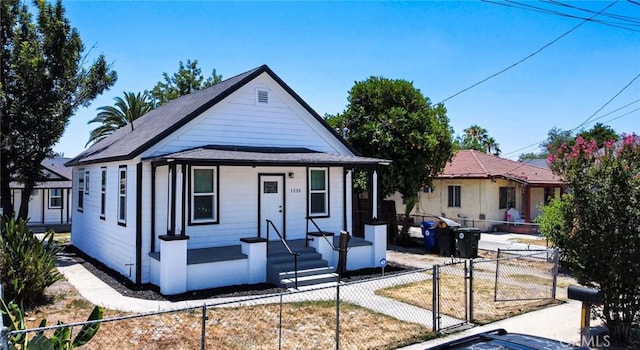 1235 Spruce St, San Bernardino, CA 92411 - view of front facade with a porch, a fenced front yard, and a gate