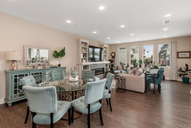 800 Grand Ave Unit 105, Carlsbad, CA 92008 - dining space with wood finished floors, a glass covered fireplace, and recessed lighting
