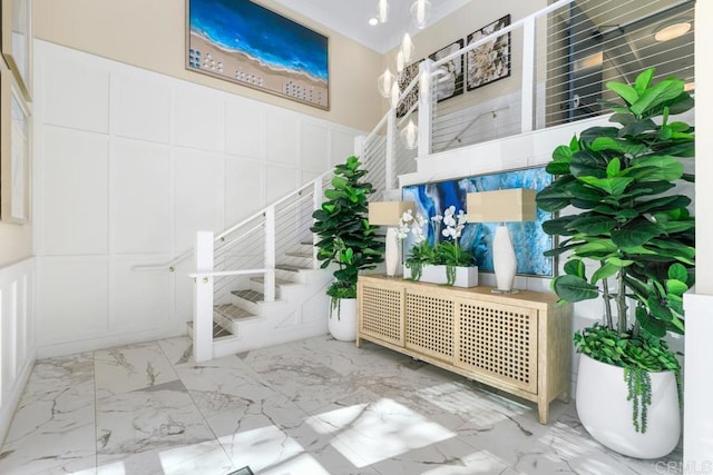 800 Grand Ave Unit 105, Carlsbad, CA 92008 - stairs with a decorative wall, marble finish floors, and a wainscoted wall