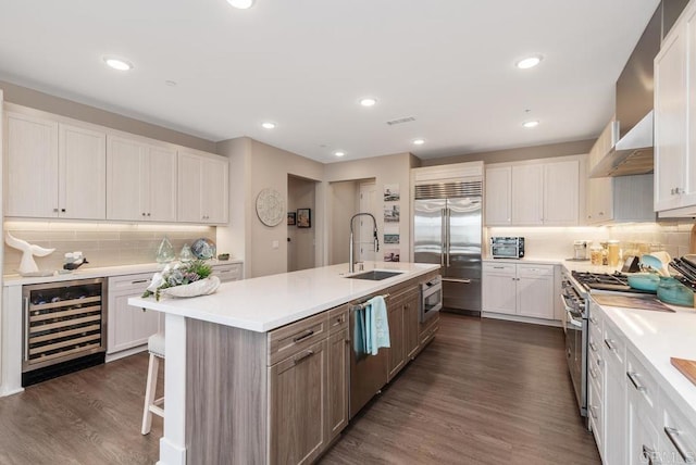 800 Grand Ave Unit 105, Carlsbad, CA 92008 - kitchen featuring beverage cooler, built in appliances, light countertops, dark wood finished floors, and recessed lighting
