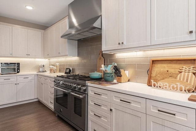 800 Grand Ave Unit 105, Carlsbad, CA 92008 - kitchen with range with two ovens, wall chimney exhaust hood, backsplash, and light countertops