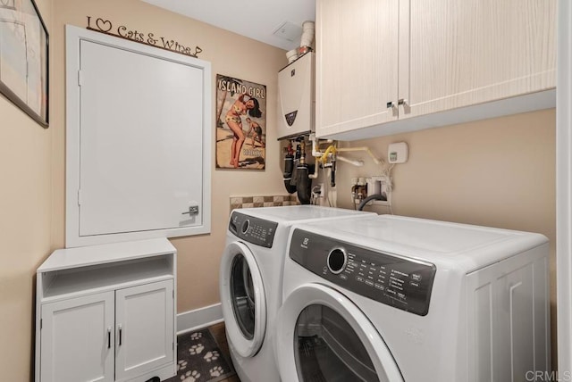 800 Grand Ave Unit 105, Carlsbad, CA 92008 - washroom with cabinet space, washer and dryer, water heater, and wood finished floors