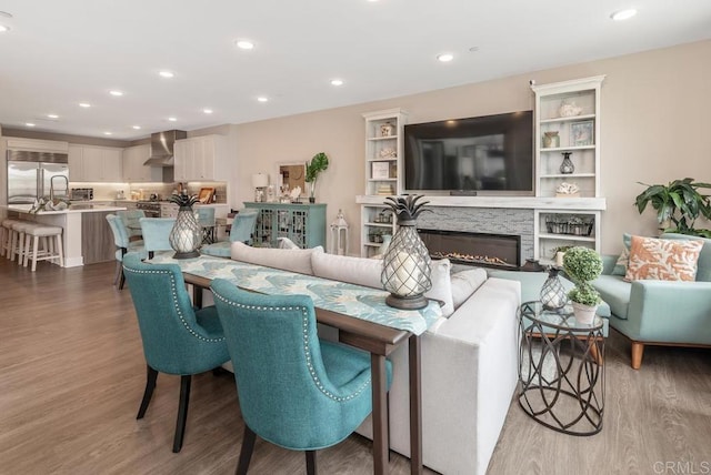 800 Grand Ave Unit 105, Carlsbad, CA 92008 - living room featuring wood finished floors, recessed lighting, and a glass covered fireplace