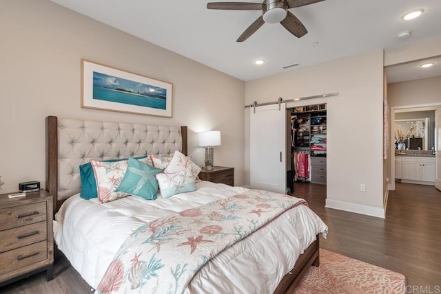 800 Grand Ave Unit 105, Carlsbad, CA 92008 - bedroom featuring a barn door, wood finished floors, a spacious closet, a closet, and recessed lighting