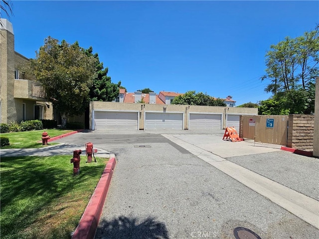 13171 Newland St Unit 11, Garden Grove, CA 92844 - view of asphalt road featuring community garages